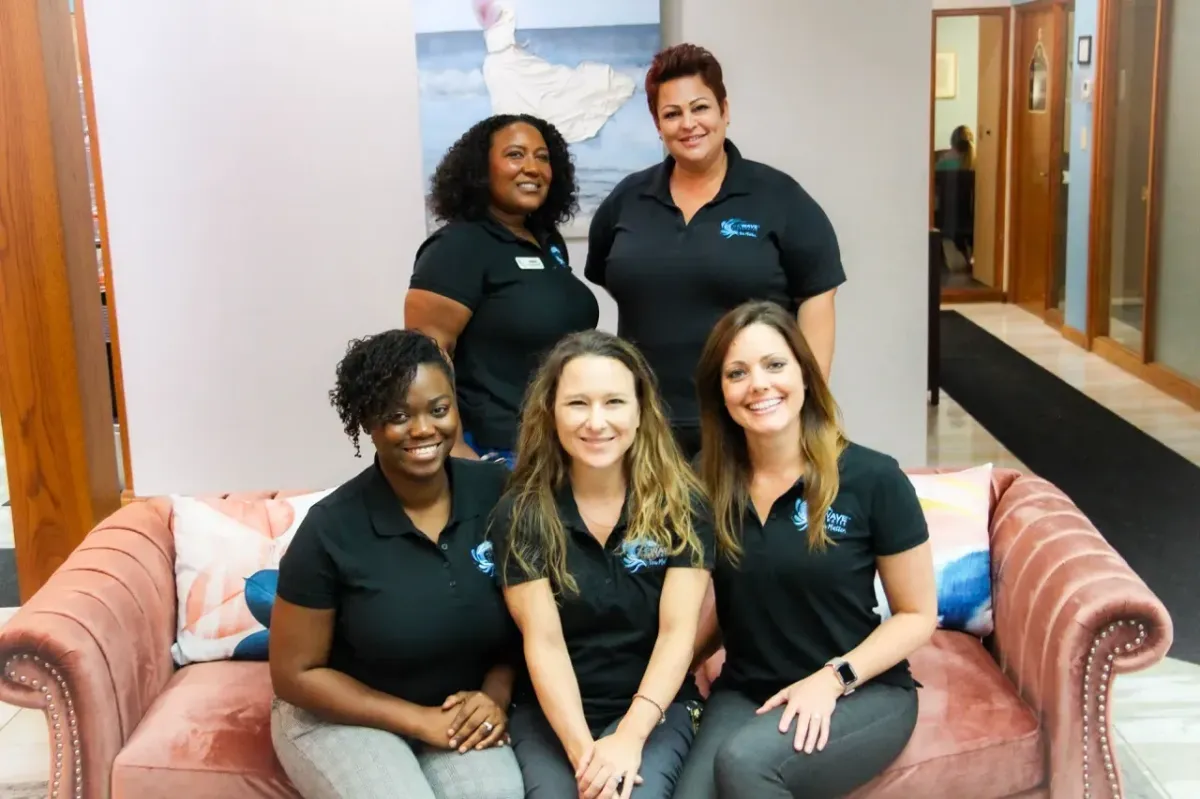 The compassionate all-women care team at The Wave, gathered in the treatment center lounge